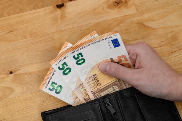 Wallet filled with euro notes