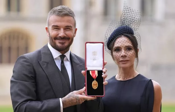 Sir David poses with his wife, Lady Victoria, after the investiture ceremony at Windsor Castle