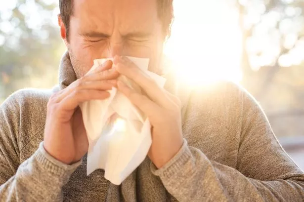 Man blowing his nose.