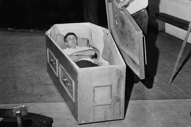 Michael 'Mick' Meaney in the coffin he spent 61 days in underground