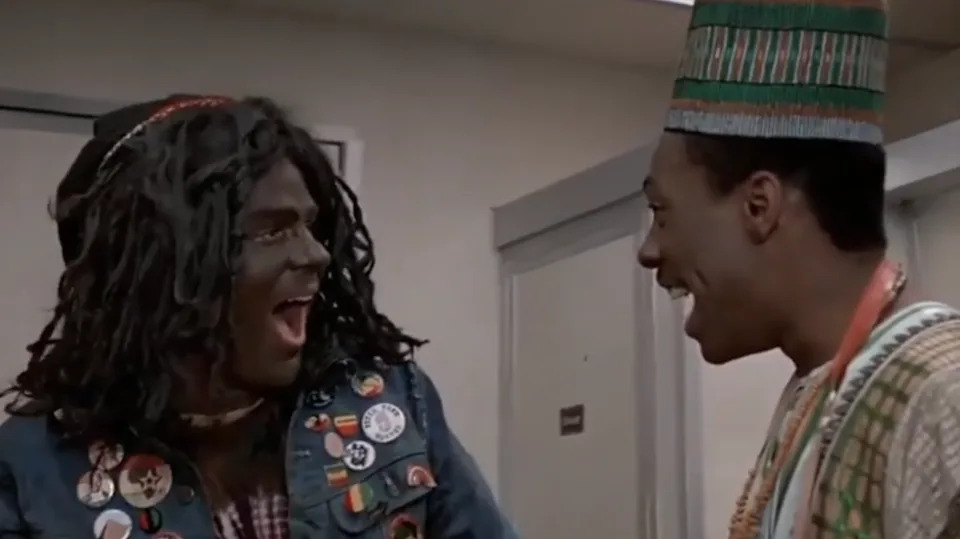 Two people in animated conversation, one is a white man using Blackface