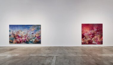 Two abstract paintings with vibrant colors displayed on a gallery wall over a polished concrete floor.