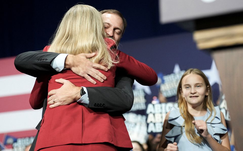 Democrat Abigail Spanberger hugs her husband, Adam Spanberger, before her victory speech over Republican Winsome Earle-Sears in Virginia's race for governor in Richmond, Virginia, U.S. November 4, 2025. REUTERS/Jay Paul