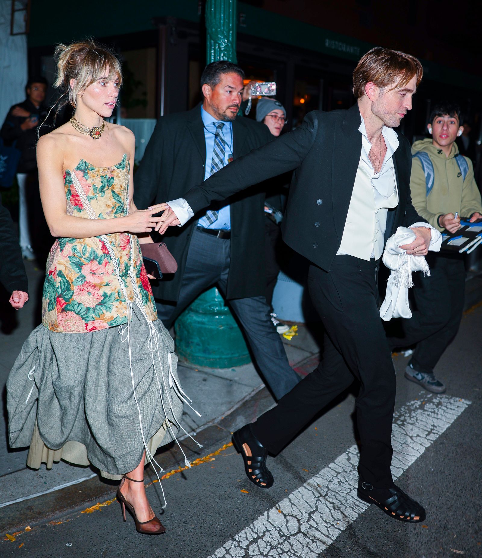 Suki Waterhouse and Robert Pattinson on an Upper West Side crosswalk.