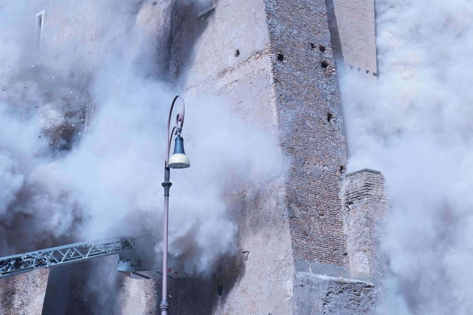 Firefighters work to rescue a construction worker from under the debris of a partially collapsed medieval tower in Rome (Domenico Stinellis/AP)
