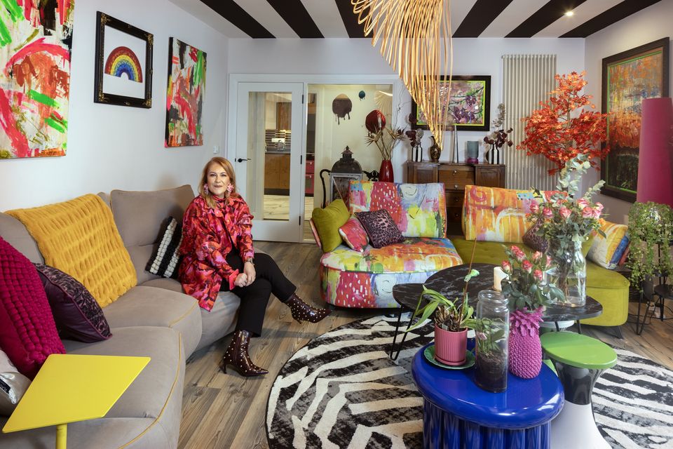 PR consultant, colour addict and painter Riki Neill in her exuberant living room with its black and white striped ceiling. Photo: Tony Gavin