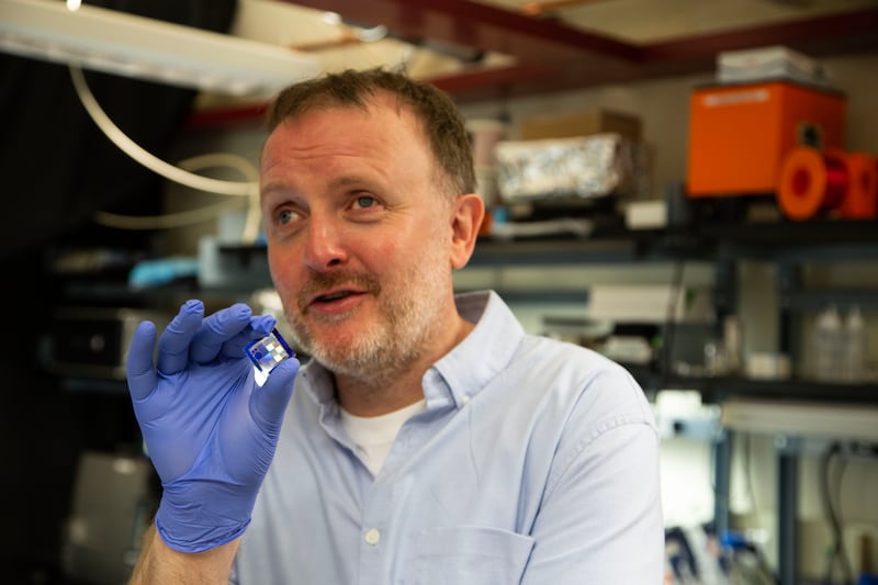 Chris McCausland holding a microchip. Photograph: Open Mike Productions/BBC