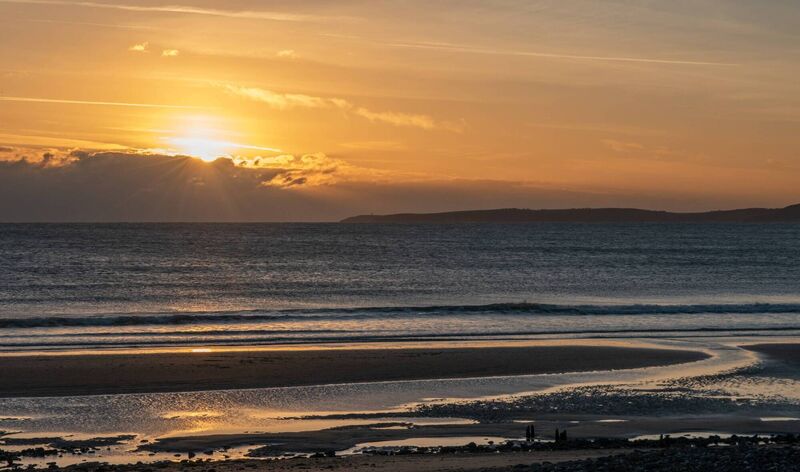 The Sun sets on the Seven Heads Peninsula and Garretstown Beach, Co Cork.  Picture: Cian O'Regan