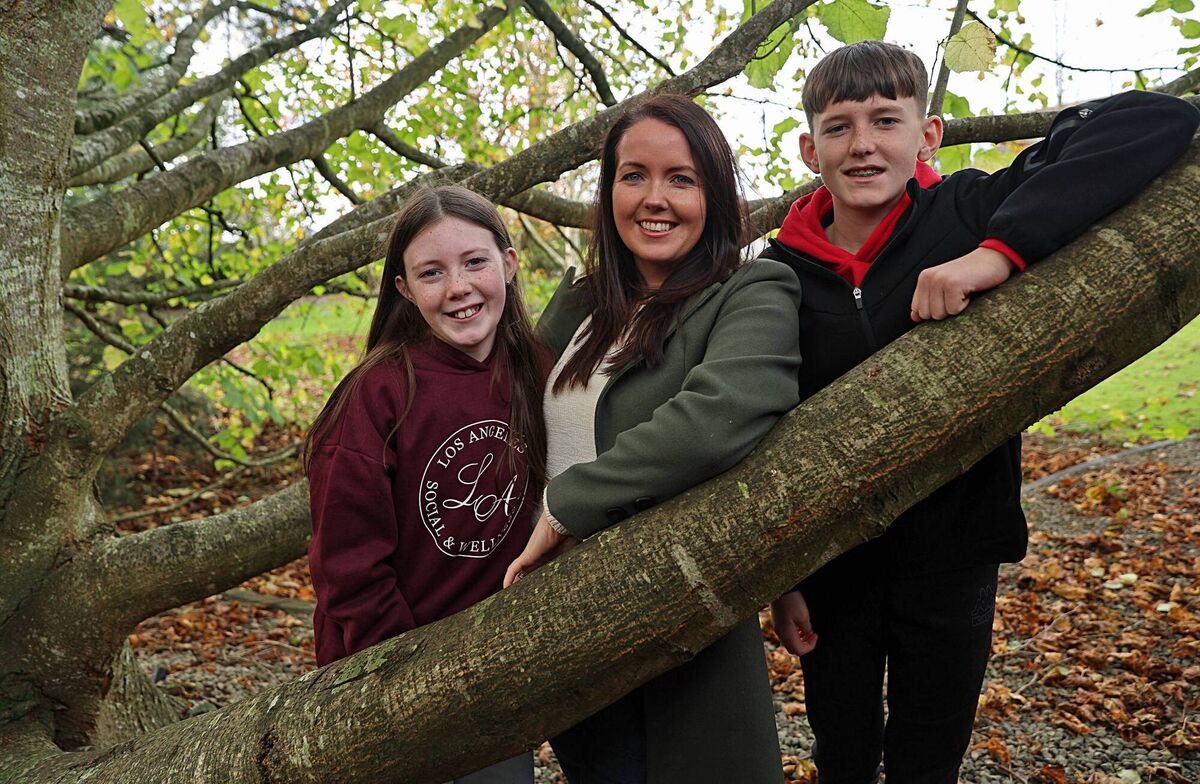 Orla Marron who has MS is mum to Katie (10) and Kyle (12). They are pictured in her parents garden outside Carrickmacross, Co. Monaghan beside her Father Brian's favourite tree. Orla's Mother, Angela also has an MS diagnosis. Photo: Lorraine Teevan