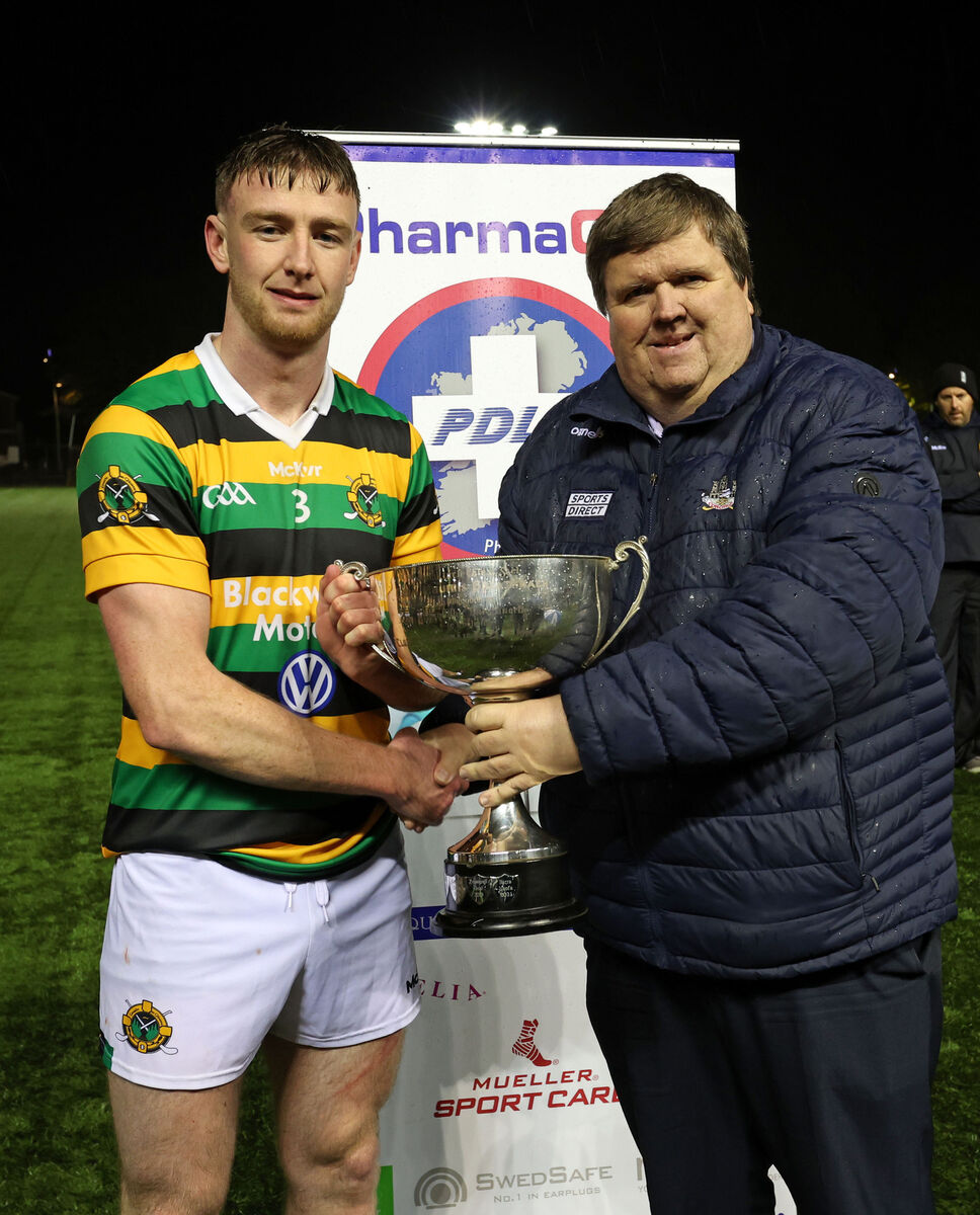  Eoghan Varian receives the Cup from Derek Connolly, Seandún GAA. Picture: Jim Coughlan.