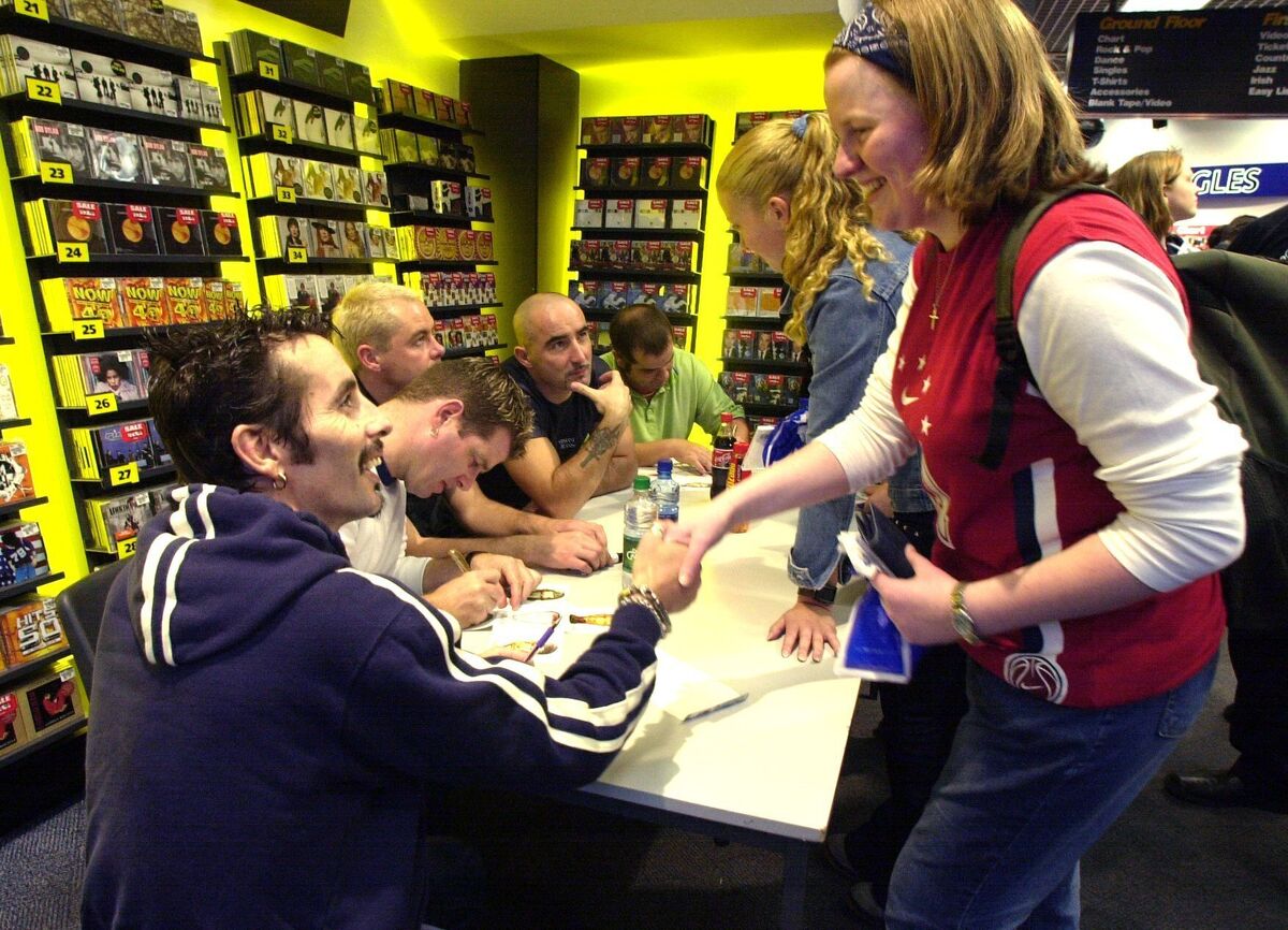 The late Christy Dignam of Aslan meets Jane Kennington while her friend Danielle Buckley chats with other band members during the signing of autographs at HMV Cork in 2001. Picture: Eddie O'Hare