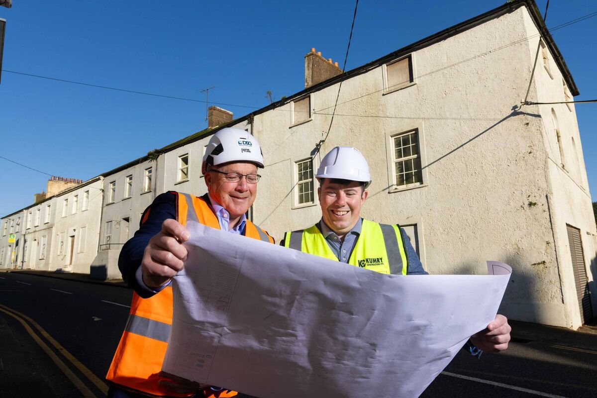 John Stoat, Operations Manager with Doyle Shipping Group, and James Vaughan, Kumry Construction, outside six Dock Terrace properties in Passage West, Cork Picture: Michael O'Sullivan/OSM PHOTO