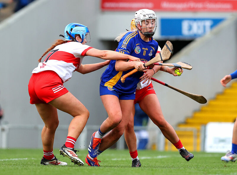 St. Finbarrs Kate Wall with De La Salle's Emma Kennedy. Pic: ©INPHO/Tom O'Hanlon.