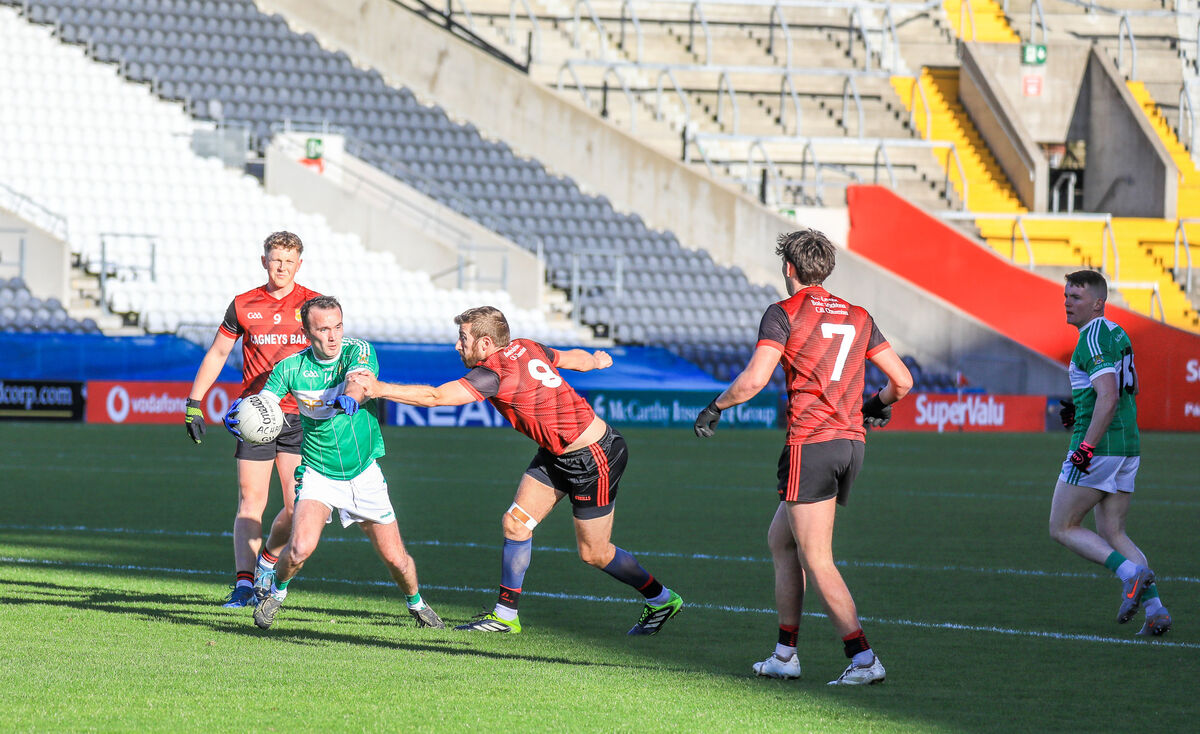 Aghabullogue's Evan O'Sullivan tries to get past Askeaton's Shane Gallagher. Picture: David Creedon