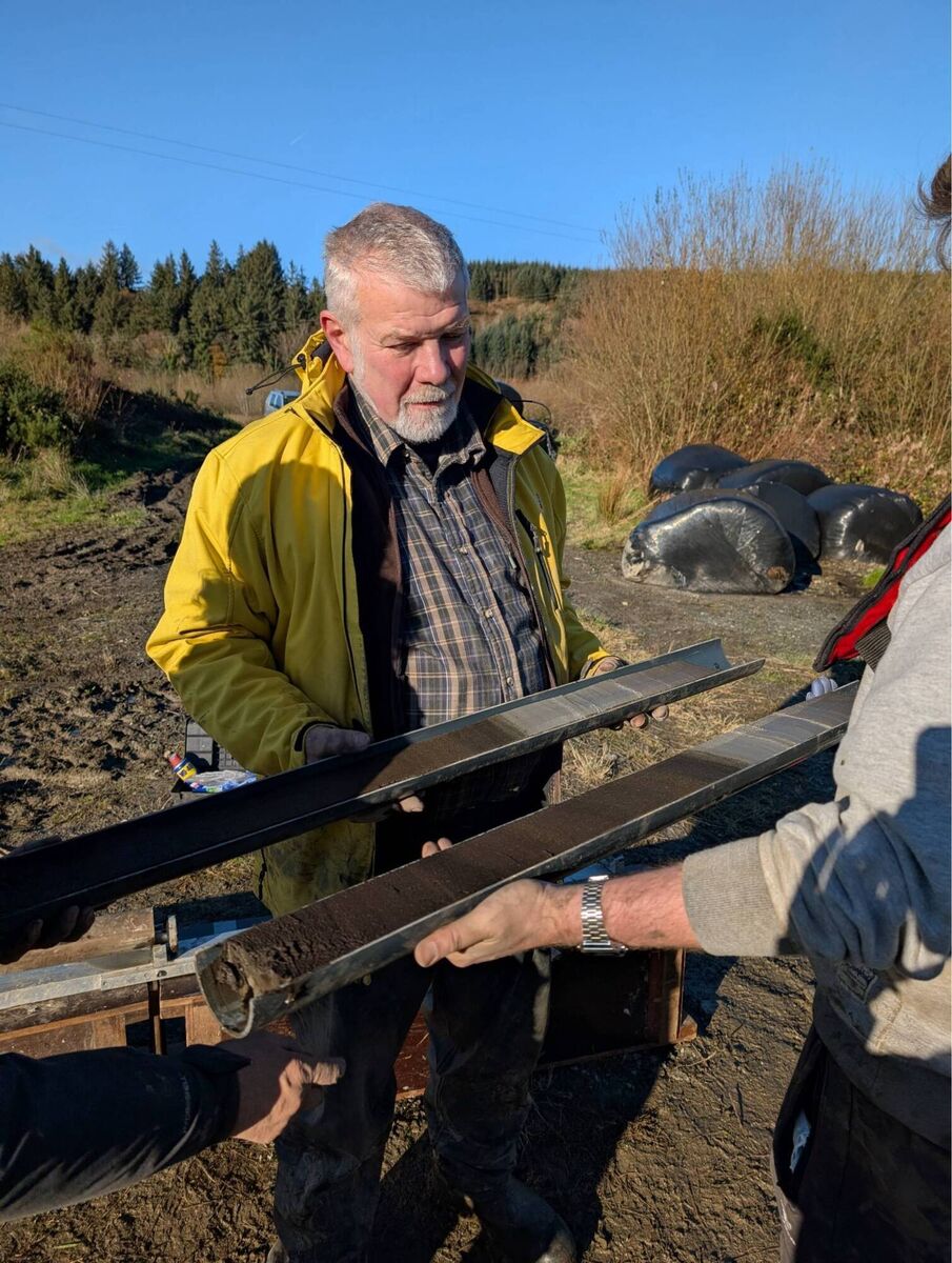 Robin Lewando (University College Cork) inspecting a split sediment core extracted from Three Lakes on November 20, 2025. Picture: Sarah Jane Power (University College Dublin).