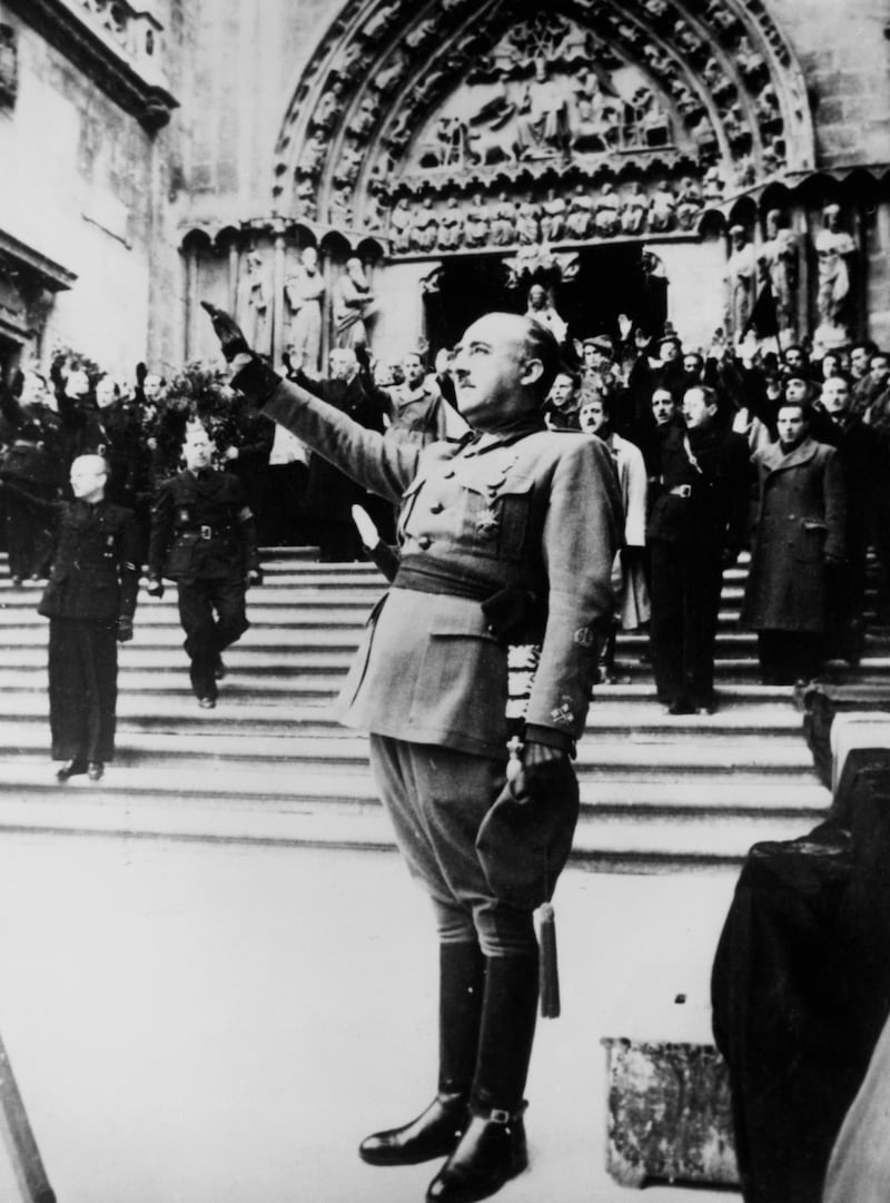 Franco salutes during the singing of the nationalist national anthem at Burgos Cathedral, Castile, Spain, in 1938. Photograph: Hulton Archive/Getty 