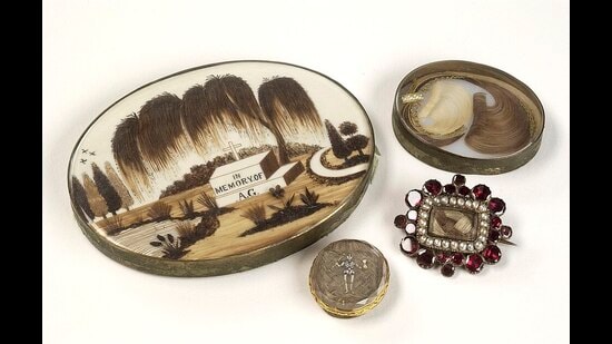 An array of mourning jewellery brooches containing hair from a lost loved one. (Wikimedia)