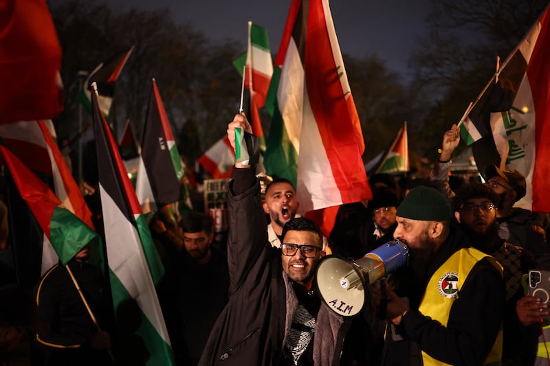 Pro-Palestinian protesters flying a variety of flags including the Palestinian flag and flag of Iraq, shout slogans during a demonstration near Villa Park last night. Photograph:  Henry Nicholls/AFP/Getty Images      