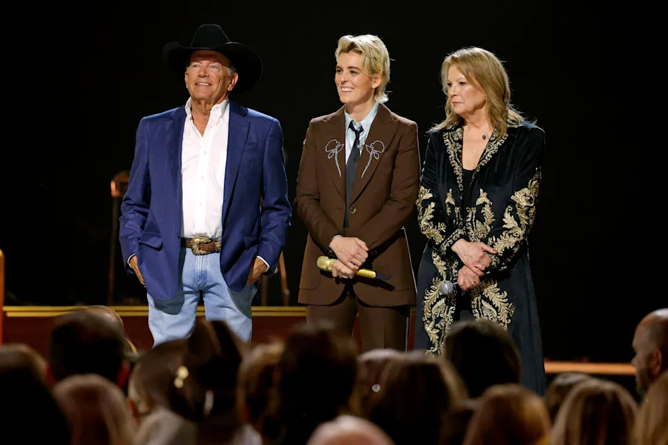 From left, George Strait, Brandi Carlile and Patty Loveless watch as Vince Gill accepts the lifetime achievement award onstage during the 59th annual CMA Awards at Bridgestone Arena on Nov. 19, 2025, in Nashville.