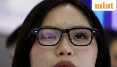 FILE PHOTO: A woman tries on a pair of Quark AI glasses by Alibaba at the company's booth at the expo of the World Internet Conference in Wuzhen town of Tongxiang city, Zhejiang province, China November 8, 2025. REUTERS/Tingshu Wang/File Photo