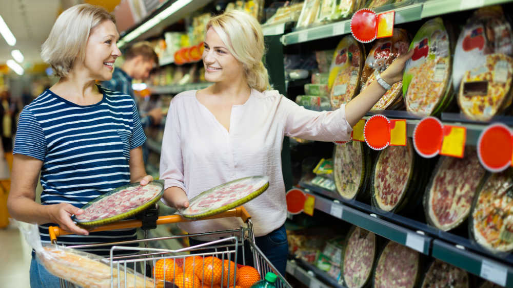 Two women shopping for food.