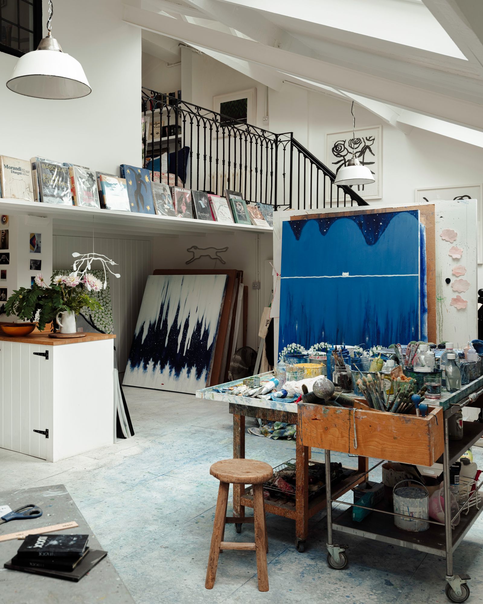 The original studio staircase leads up to a mezzanine where the bedroom and bathroom are located.