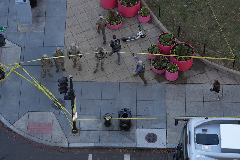 Members of various law enforcement agencies near where two members of the National Guard were shot in Washington, DC. Photograph: Eric Lee/The New York Times
                      