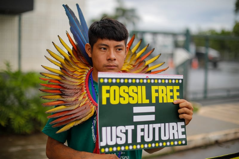 An Indigenous activist protests during the pre-COP30 preparatory meeting that gathers ministers in charge of climate negotiations. Photograph: Sergio Lima/ AFP via Getty Images