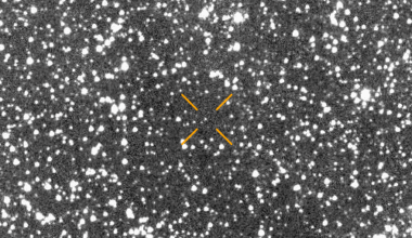 A faint, slightly yellowish point of light—Comet 3I/ATLAS—appears near the center of a grainy, brown-toned background captured by the SOHO/LASCO C3 coronagraph between October 15–26, 2025. The comet is only marginally brighter than the surrounding noise, making it difficult to distinguish.