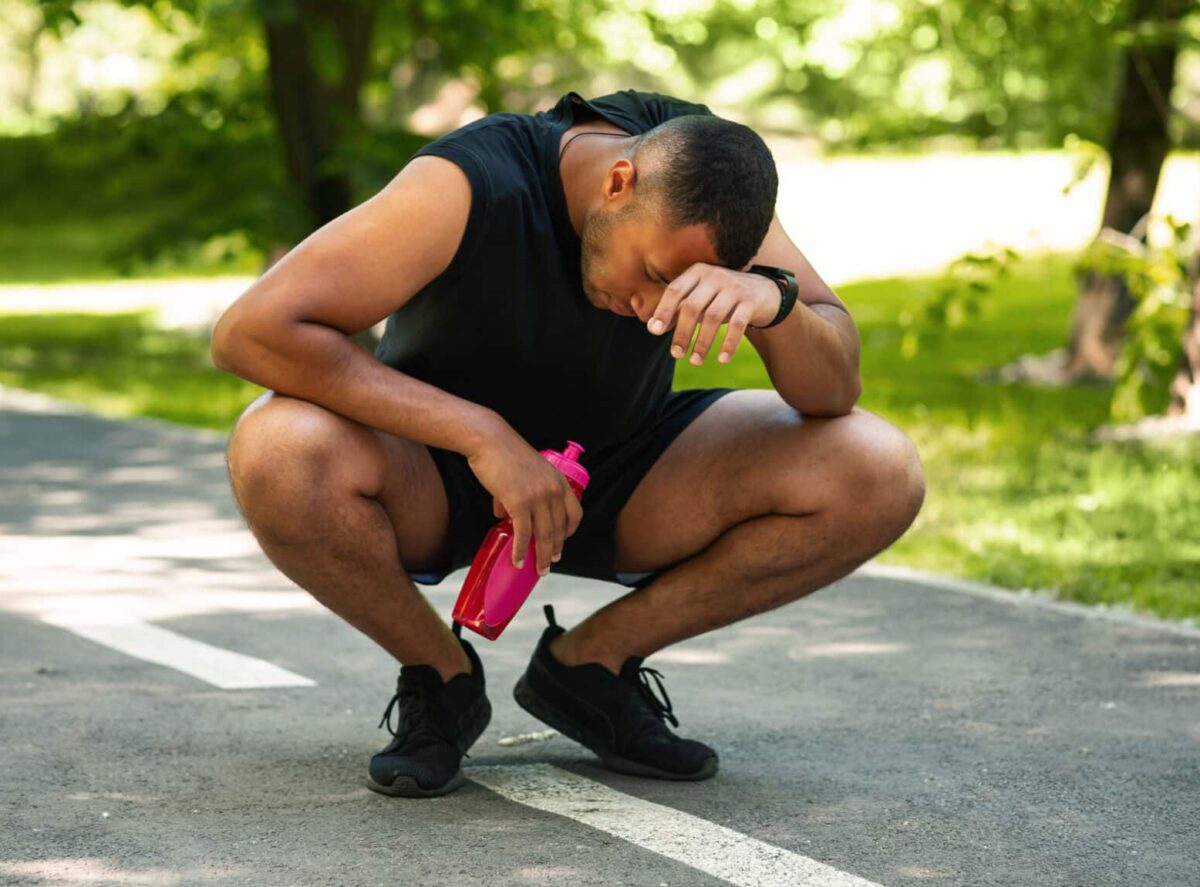 An exhausted man tired from running or exercising