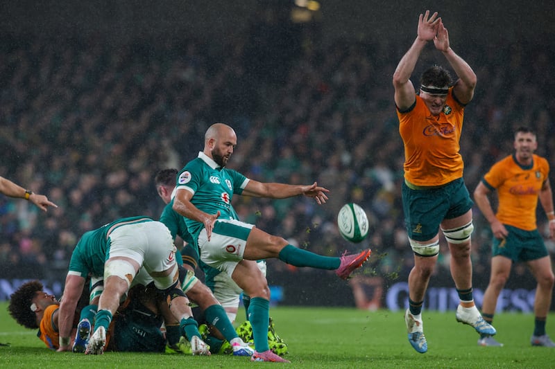 Australia's lock Tom Hooper (R) attempts to block a kick from Ireland's scrum-half Jamison Gibson-Park (C) during the Autumn Nations Series international rugby union match between Ireland and Australia at the Aviva Stadium in Dublin, on November 15, 2025. (Photo by Paul Faith / AFP) (Photo by PAUL FAITH/AFP via Getty Images)          