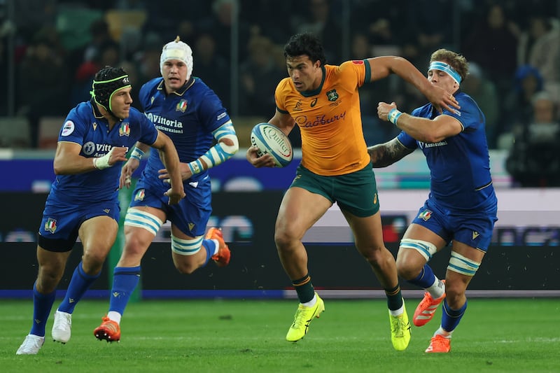 Joseph-Aukuso Suaalii of Australia makes a break from Italian players during their Quilter Nations Series game in Udine, Italy on Saturday. Photograph: Timothy Rogers/Getty Images