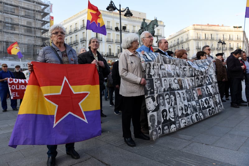 A woman holds the Spanish republican flag during a protest in Madrid against the impunity for the crimes committed during the Spanish dictatorship of Francisco Franco. Photograph:  Jorge Sanz/Getty 