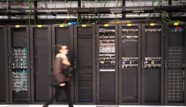 A visitor walks past a computer bay at the PA10 data center, operated by Equinix Inc., in Paris, France.