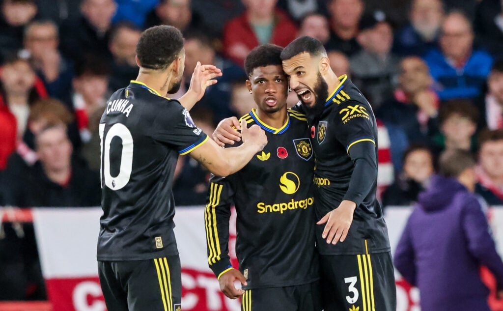 Amad Diallo celebrates with Noussair Mazraoui and Matheus Cunha during the Premier League match between Nottingham Forest and Manchester United at City Ground in 2025 in Nottingham, England.