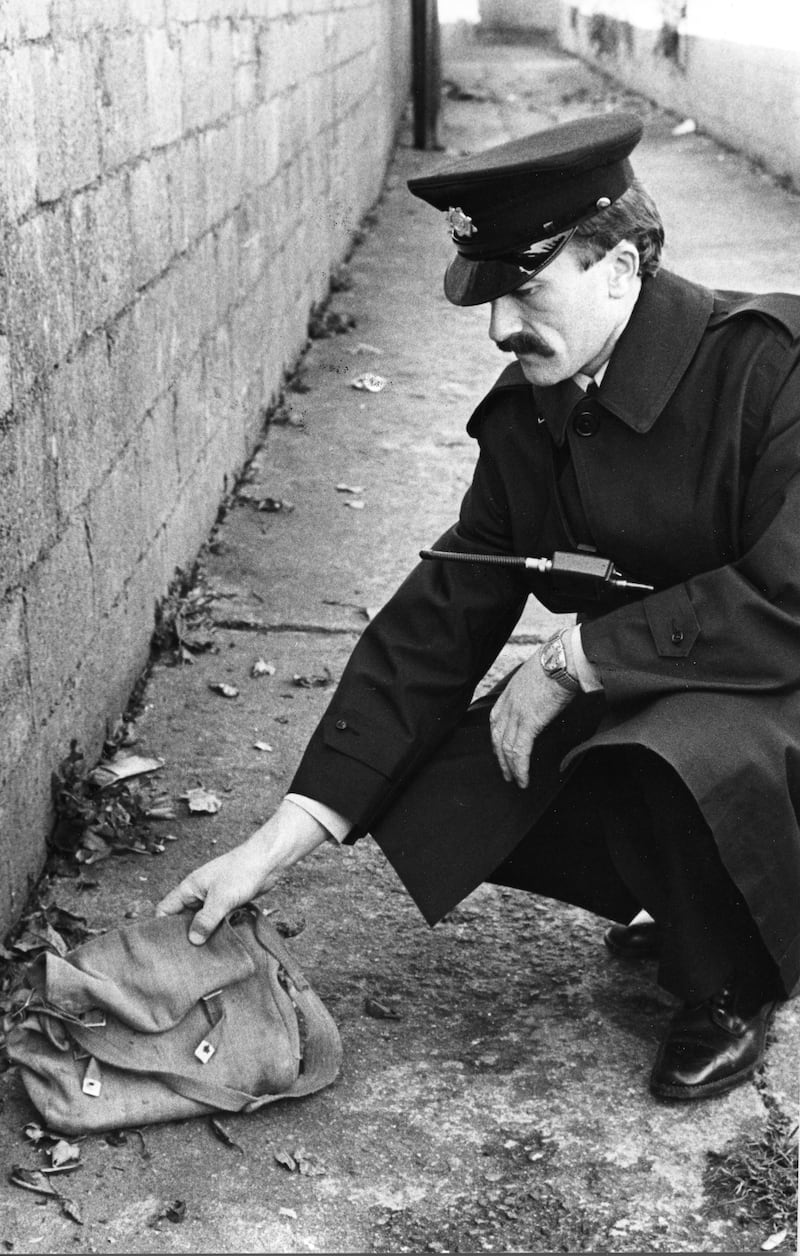 Garda Pat Sheehan in a laneway off Anne Devlin Road, Rathfarnham , Co Dublin, where the schoolbag belonging to Philip Cairns was found. File photograph: Kevin McMahon/The Irish Times
