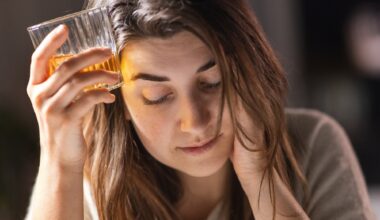 female alcoholic drinking whiskey at home