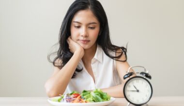 Woman looking at meal waiting time to eat during intermittent fasting session