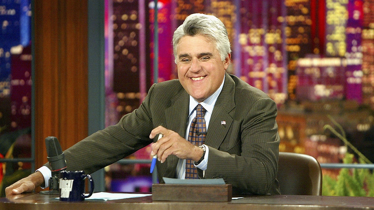 Jay Leno seated at his desk on "The Tonight Show"