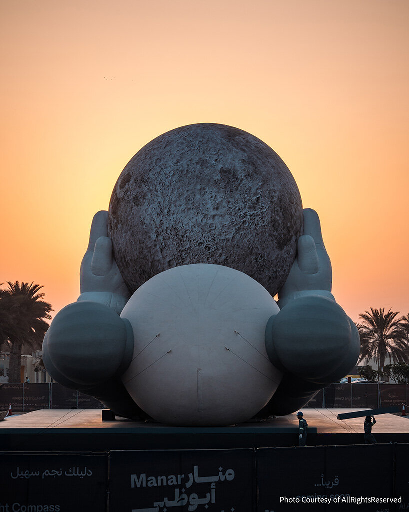 32-meter companion by KAWS lifts glowing moon along abu dhabi's waterfront