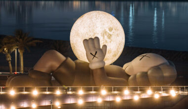 KAWS' companion lifts glowing moon along abu dhabi's waterfront
