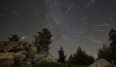 A view of the night sky with light streaks scattered about.