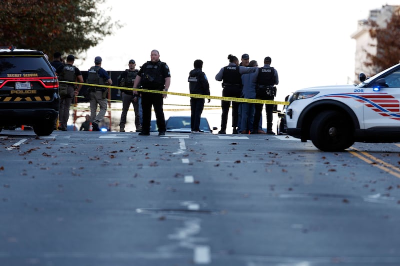 Police stand close to the scene where two West Virginia National Guard members were shot in Washington, DC. Photograph: EPA