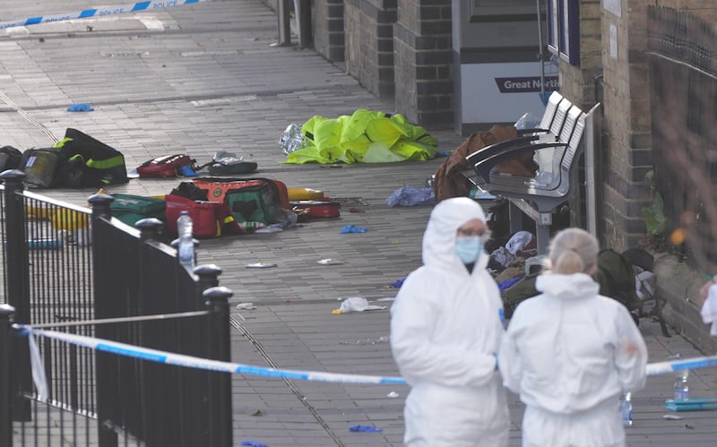 Forensic investigators at Huntingdon train station in England on Sunday. Photograph: Joe Giddens/PA Wire