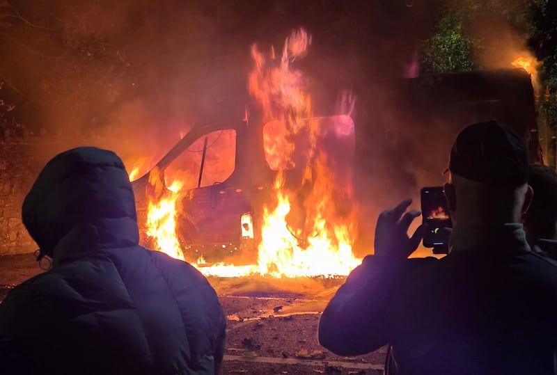 A Garda van set of fire outside Citywest hotel on the first night of the recent riots. Photograph: Colin Keegan/Collins