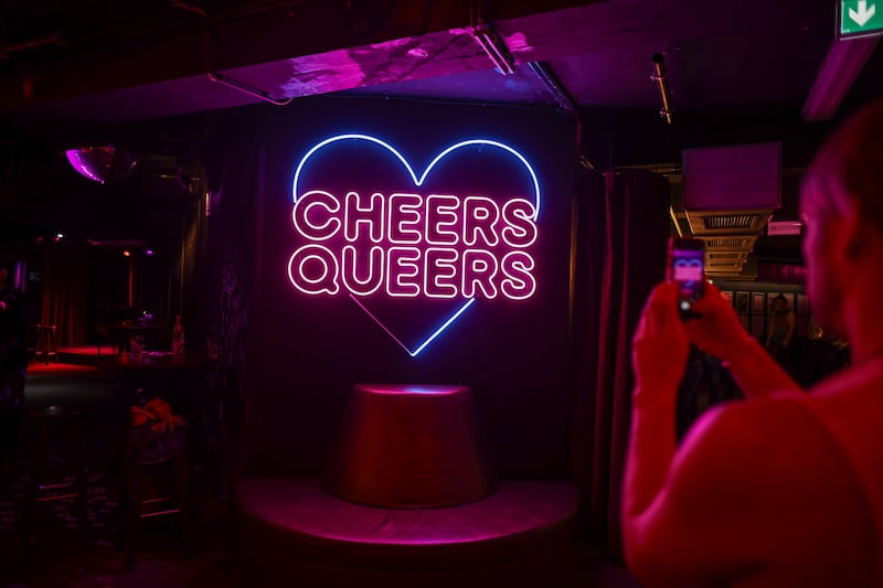 A guest snaps a photo of the famous neon sign at SchwuZ. Photograph: Omer Messinger/Getty Images