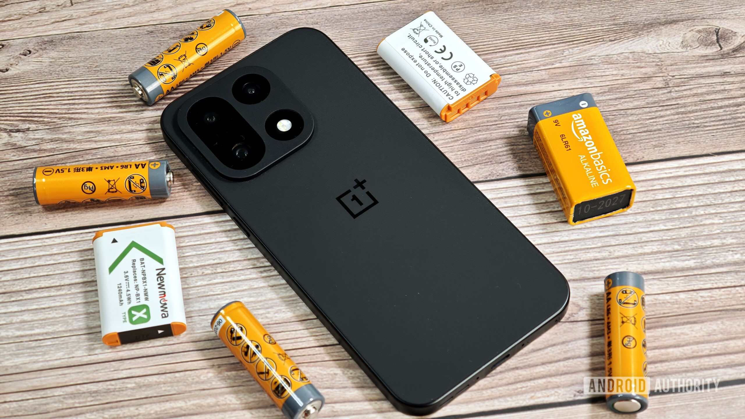 OnePlus 15 surrounded by batteries