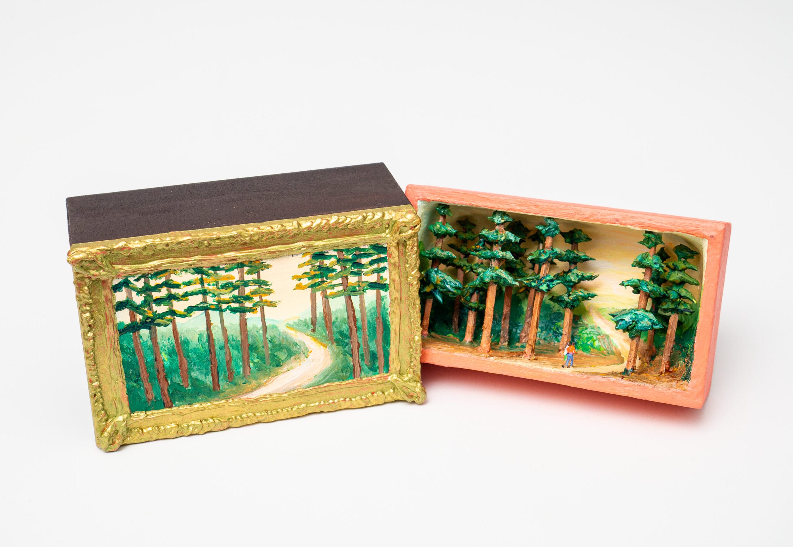 a matchbox by Barry Hazard of a gold framed landscape that opens to reveal a small wooded diorama