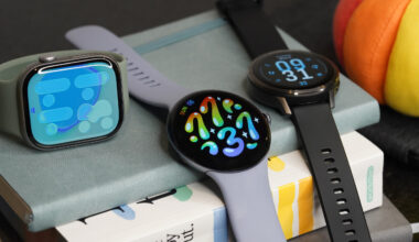 A Pixel Watch 4 rests on a pile of books with smartwatch alternatives.