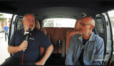 Jim Garrett and Josh Cooperman sitting inside the podcast van